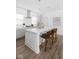 White kitchen island with four mid-century modern stools at 2849 N Washington N Blvd, Indianapolis, IN 46205