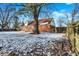 Brick house backyard with snow-covered ground, large tree, and wooden fence at 2934 S Irwin St, Indianapolis, IN 46203