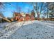 Brick house backyard with snow covered ground, wooden fence, and large trees at 2934 S Irwin St, Indianapolis, IN 46203