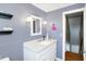 Bathroom with gray walls, white vanity, and window at 2934 S Irwin St, Indianapolis, IN 46203