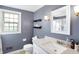 Bathroom with gray walls, white vanity, and window at 2934 S Irwin St, Indianapolis, IN 46203