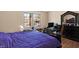 Bedroom with large bed, hardwood floors, and walk-in closet at 2934 S Irwin St, Indianapolis, IN 46203