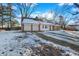Ranch home with a two-car garage and a gravel driveway, covered in snow at 2934 S Irwin St, Indianapolis, IN 46203