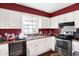 L-shaped kitchen with white cabinets and stainless steel appliances at 2934 S Irwin St, Indianapolis, IN 46203