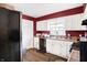 Galley kitchen, white cabinets, and stainless steel appliances at 2934 S Irwin St, Indianapolis, IN 46203