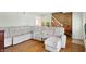 Living room with a sectional sofa and hardwood floors, near the stairs at 2934 S Irwin St, Indianapolis, IN 46203