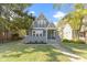 Charming gray house with green door, landscaped lawn, and walkway at 326 N Arlington Ave, Indianapolis, IN 46219