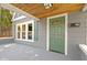 Inviting front porch with green door and wood ceiling at 326 N Arlington Ave, Indianapolis, IN 46219