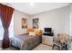 Cozy bedroom with a comfortable bed, orange pillows, and a TV at 3844 Albert Ln, Bargersville, IN 46106