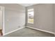 Empty bedroom with a window view of a house at 3844 Albert Ln, Bargersville, IN 46106