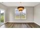 Modern dining area featuring wood floors, a stylish chandelier, and a view of the outdoor landscape at 3844 Albert Ln, Bargersville, IN 46106