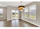 Light filled dining area featuring stylish light fixture and sliding glass doors with backyard views at 3844 Albert Ln, Bargersville, IN 46106