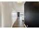 Hallway with wood floors, leading to an open-concept living space with a fireplace and modern kitchen at 3844 Albert Ln, Bargersville, IN 46106