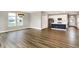Bright and airy living room with wood floors, leading to a modern kitchen with white cabinets and stainless appliances at 3844 Albert Ln, Bargersville, IN 46106