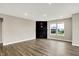 Minimalist living room featuring wood floors, a contemporary fireplace, and large windows offering natural light at 3844 Albert Ln, Bargersville, IN 46106