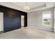 Spacious main bedroom featuring a black accent wall and elegant chandelier lighting at 3844 Albert Ln, Bargersville, IN 46106