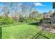 A spacious backyard with lush green grass, and mature trees at 386 White Oak Ln, Greenwood, IN 46142