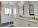 This bathroom features a double sink vanity, white subway tile, and a glass enclosed shower at 386 White Oak Ln, Greenwood, IN 46142