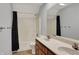 Bathroom with double sink vanity, a shower with a black curtain, and tile flooring at 386 White Oak Ln, Greenwood, IN 46142