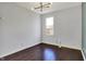 Cozy bedroom with modern light fixture and dark wood floors, offering a simple, stylish retreat at 386 White Oak Ln, Greenwood, IN 46142
