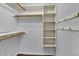 Walk in closet with shelves, wood closet rods, and hooks for organized storage at 386 White Oak Ln, Greenwood, IN 46142