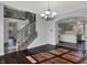 Dining room leading to kitchen, features hardwood floors, neutral colors, and staircase at 386 White Oak Ln, Greenwood, IN 46142