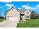 Charming two-story brick home featuring an attached two-car garage and a well-manicured front yard at 386 White Oak Ln, Greenwood, IN 46142