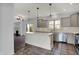 Bright kitchen with gray cabinets, a white center island, and stainless steel appliances is perfect for entertaining at 386 White Oak Ln, Greenwood, IN 46142
