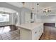 Open concept kitchen with white island and views of the living and dining area is great for gatherings at 386 White Oak Ln, Greenwood, IN 46142