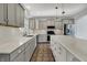 This kitchen features gray cabinets, quartz countertops, stainless steel appliances, and a center island at 386 White Oak Ln, Greenwood, IN 46142