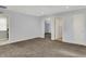 Open-plan living room boasts carpet, recessed lighting, and neutral-colored walls at 386 White Oak Ln, Greenwood, IN 46142
