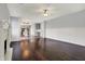 Spacious living room with dark wood floors, fireplace, and open layout to the kitchen for modern living at 386 White Oak Ln, Greenwood, IN 46142