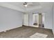 Spacious main bedroom features tray ceiling, carpet, and a sliding barn door to the ensuite bath at 386 White Oak Ln, Greenwood, IN 46142