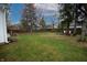 Large grassy backyard enclosed by a wooden fence and surrounded by mature trees at 4232 Bunting Ln, Columbus, IN 47203