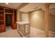 Close up of the basement featuring bar with glass block and support beam, plus access to the stairs at 4232 Bunting Ln, Columbus, IN 47203