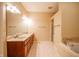 Bathroom with double sink vanity, a walk-in shower, and a soaking tub at 4232 Bunting Ln, Columbus, IN 47203