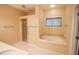 Bathroom featuring a soaking tub with tile surround and a separate shower stall at 4232 Bunting Ln, Columbus, IN 47203