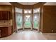 Cozy breakfast nook with ample natural light from bay windows overlooking backyard at 4232 Bunting Ln, Columbus, IN 47203