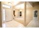 Foyer with high ceilings, neutral walls, and tile flooring adjacent to a dining room with modern lighting at 4232 Bunting Ln, Columbus, IN 47203