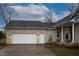 Home exterior with attached garage, brick exterior, and a well-maintained lawn at 4232 Bunting Ln, Columbus, IN 47203