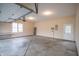 Spacious garage featuring concrete flooring, window, shelving and ample room for vehicles and storage at 4232 Bunting Ln, Columbus, IN 47203