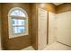 Hallway featuring a decorative window and white doors at 4232 Bunting Ln, Columbus, IN 47203