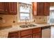 A closer look at a kitchen sink with granite countertops and wood cabinets at 4232 Bunting Ln, Columbus, IN 47203