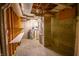 Unfinished basement with exposed ceiling, water heater, and white work table at 4232 Bunting Ln, Columbus, IN 47203
