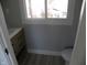 Small bathroom with vanity, toilet, and window at 4712 Caroline Ave, Indianapolis, IN 46205