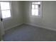 Bright bedroom with gray carpet and two windows at 4712 Caroline Ave, Indianapolis, IN 46205