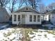 Beige house with white trim and a sunroom at 4712 Caroline Ave, Indianapolis, IN 46205