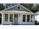 Cute bungalow with white trim and a spacious front porch at 4712 Caroline Ave, Indianapolis, IN 46205