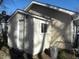 Rear view of tan house with small shed at 4712 Caroline Ave, Indianapolis, IN 46205