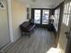 Sunroom with leather couch and wood-look floors at 4712 Caroline Ave, Indianapolis, IN 46205